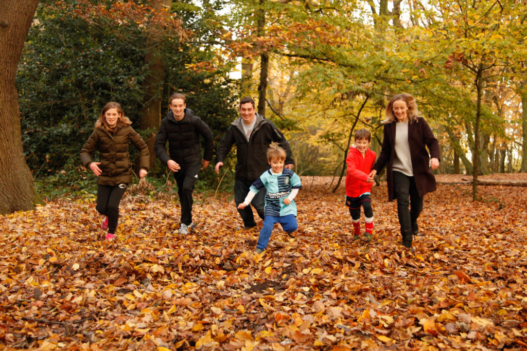 family running in the leaves