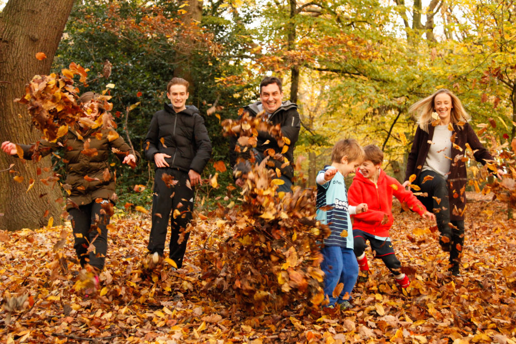 family running in the leaves